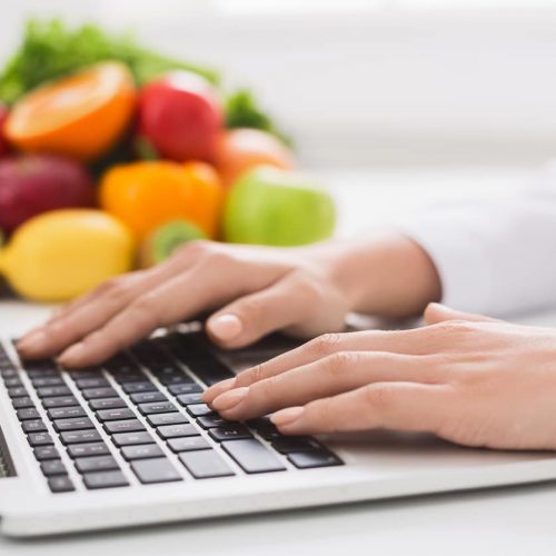 Healthy eating and food coach concept. Nutritionist consultation online, dietitian typing treatment to patient via internet, copy space